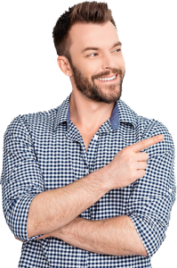 Smiling man in a checkered shirt points to the right against a blue background.