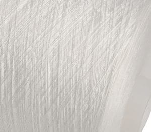 Close-up of white fabric with diagonal, ribbed texture and soft folds