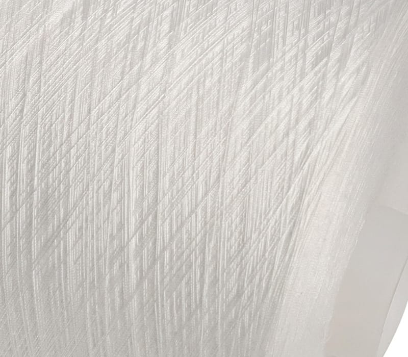 Close-up of white fabric with diagonal, ribbed texture and soft folds