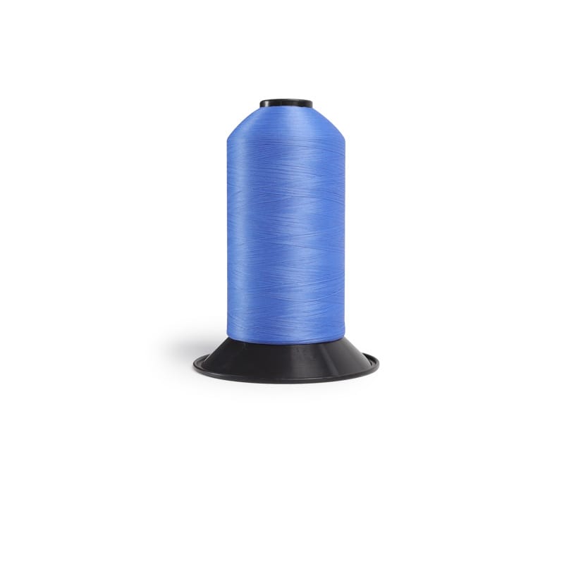 Blue spool of thread on a black sewing stand/holder.