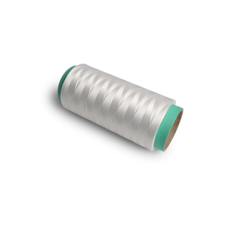 Spool of silver sewing thread with teal ends on a white background, viewed at an angle to show the wrapping around the core.