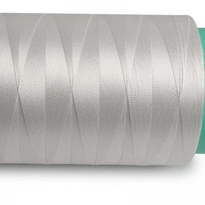 Close-up of a large spool of metallic silver thread wound around a teal core.