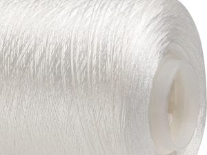 Close-up of white sewing thread wound around a plastic spool core.