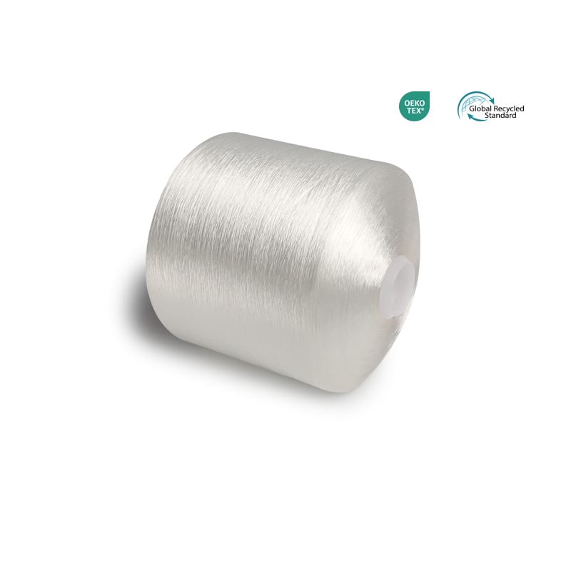 Silver spool of metallic thread on a white background with OEKO-TEX and Global Recycled Standard logos in the corner