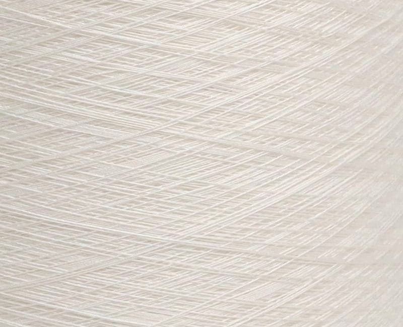 Close-up of pale beige yarn or thread with fine fibers crosshatching in a woven texture.