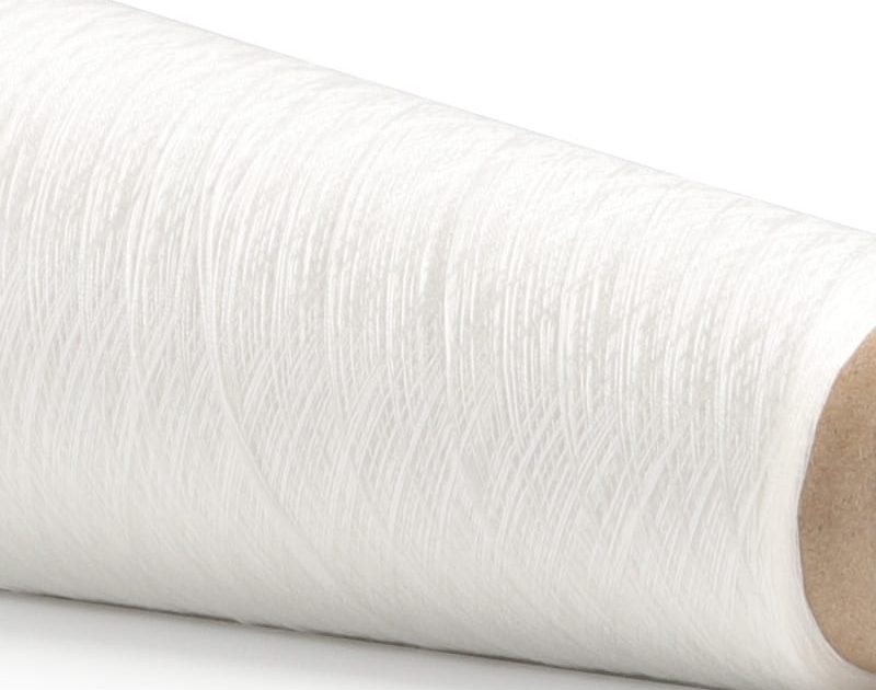 Close-up of a white rolled bandage with a textured fabric surface.